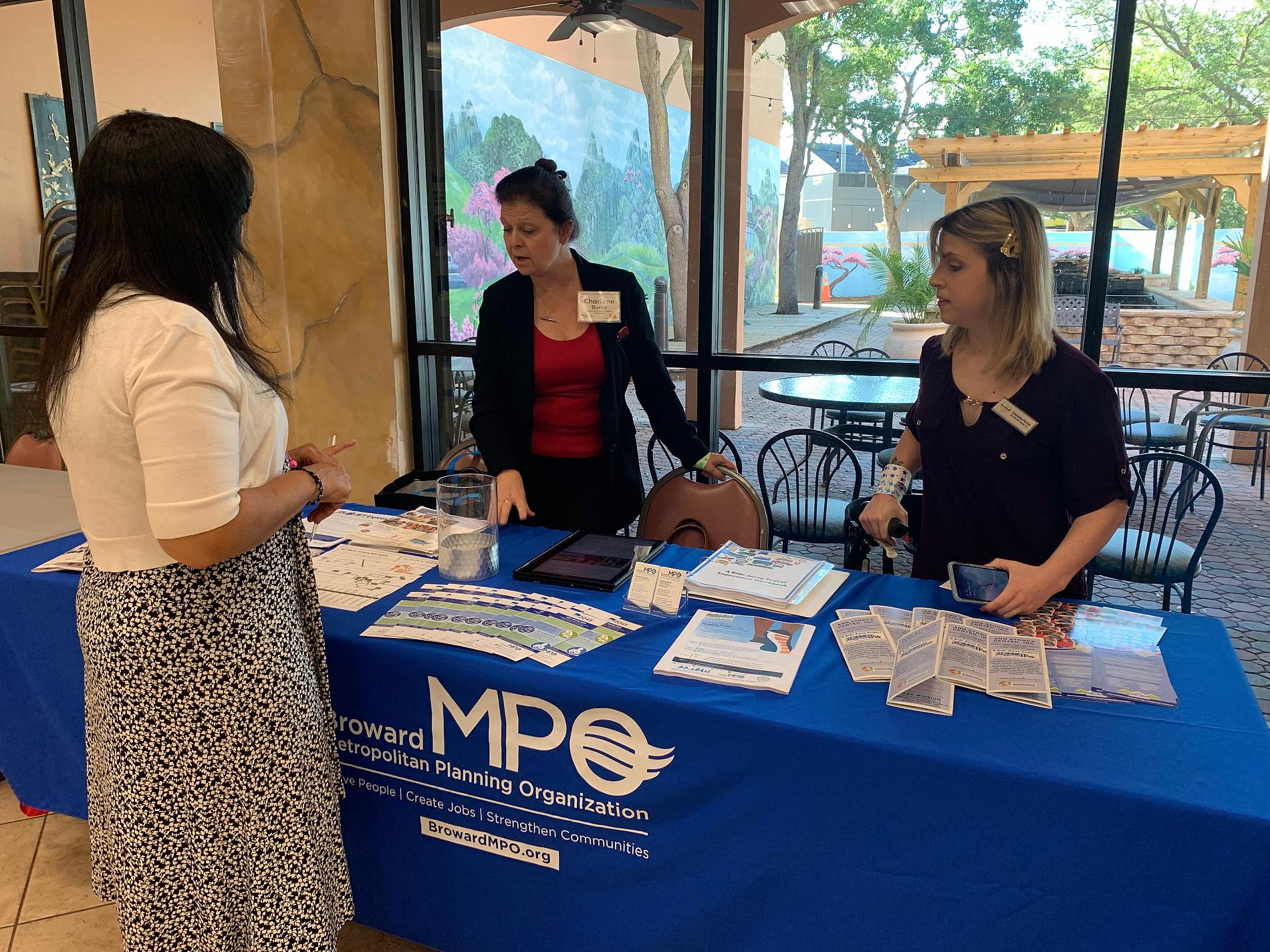 Charlene and Danielle talking to a conference participant